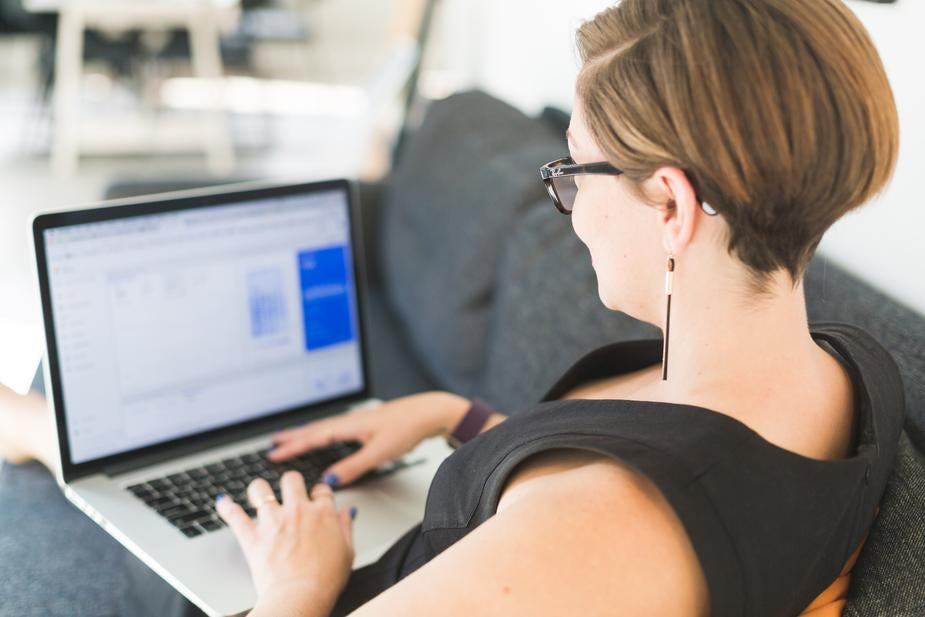 Woman Working On Office Sofa